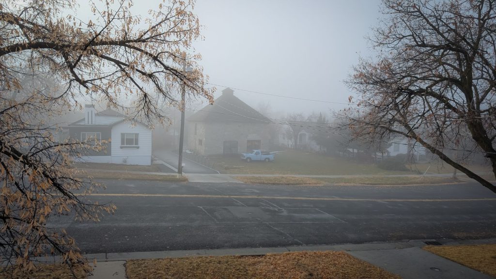 The Carriage House, also known as the Old Barn, sits shrouded in fog in Logan, Utah.