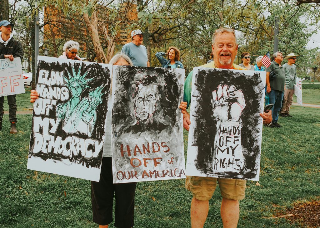 People advocate for democracy at a protest. Leveraging a sortition-based system of governance could shrink the gap between Americans' needs and the laws passed by legislators. Photo by Barbara Burgess.