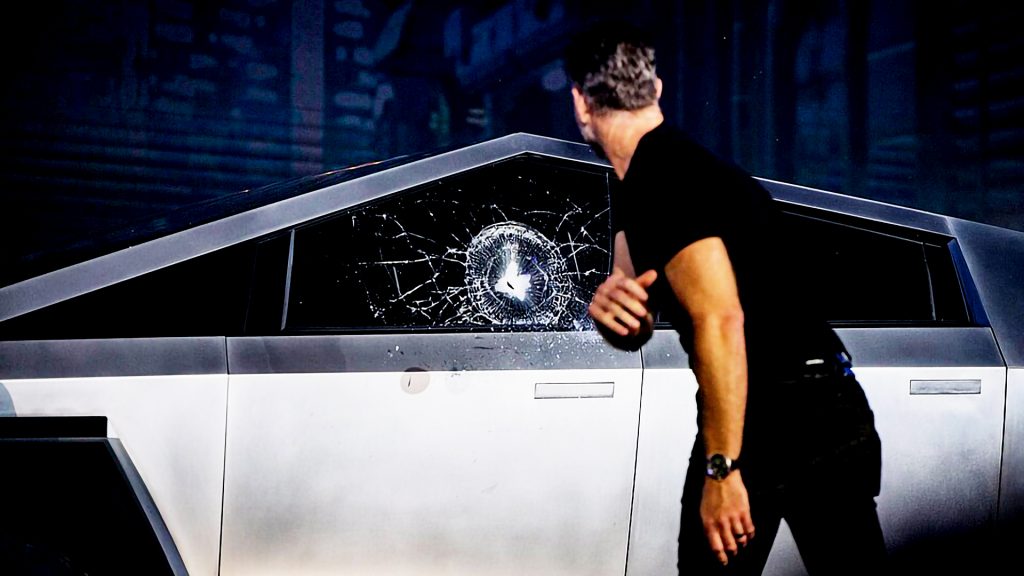 Chief Designer of Tesla throws a steel ball at the window of Cybertruck. The impact, meant to showcase the durability of Tesla glass, instead shattered the Cybertruck's window during the live unveiling event. Somehow it feels like a great metaphor for our tax system as well. Photo: u/Kruzat via Wikimedia Commons, CC-BY-SA 4.0.
